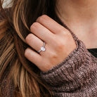 Sterling silver oval lab-grown diamond engagement ring by Delmar, worn on hand