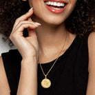 Yellow-plated sterling silver zodiac pendant necklace worn on model by Lord & Taylor