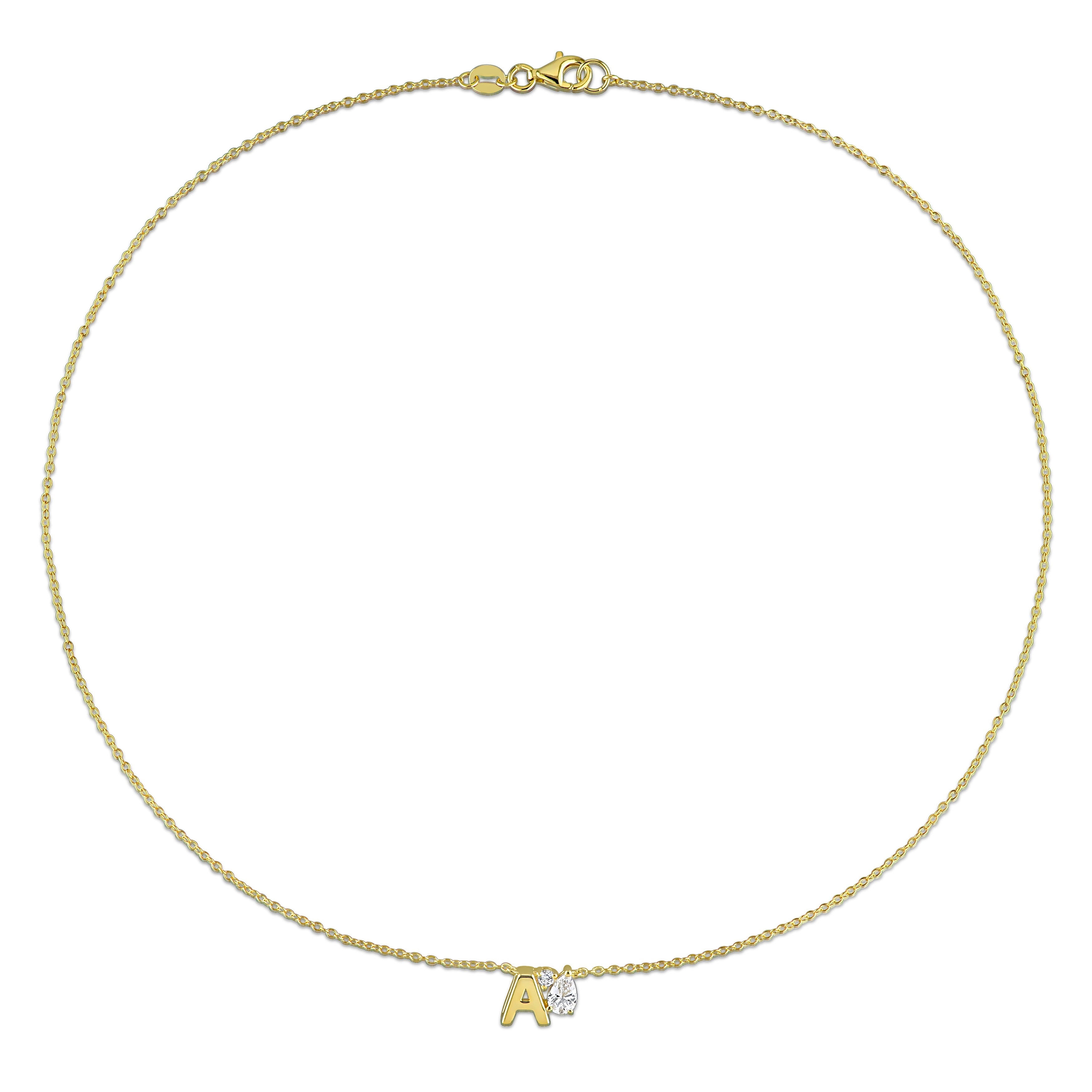 Yellow-plated initial pendant necklace detail view showing pear-cut sapphire by Lord & Taylor
