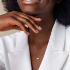 Yellow-plated initial pendant necklace lifestyle view worn with casual attire by Lord & Taylor