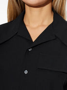 Black wool mid-thigh shirt dress by AMI Paris, alternate angle on model