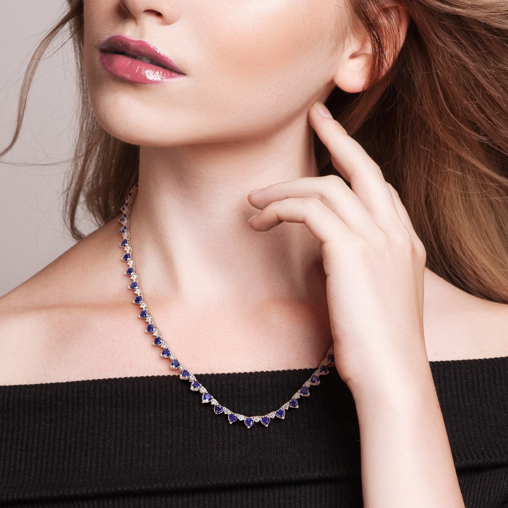 Blue sapphire heart tennis necklace worn on model by Lord & Taylor