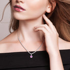 Pink sapphire halo tennis necklace worn on model, lifestyle view