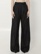 Black muslin wide leg trousers with high waist and pressed pleats by THE LATEST, front view