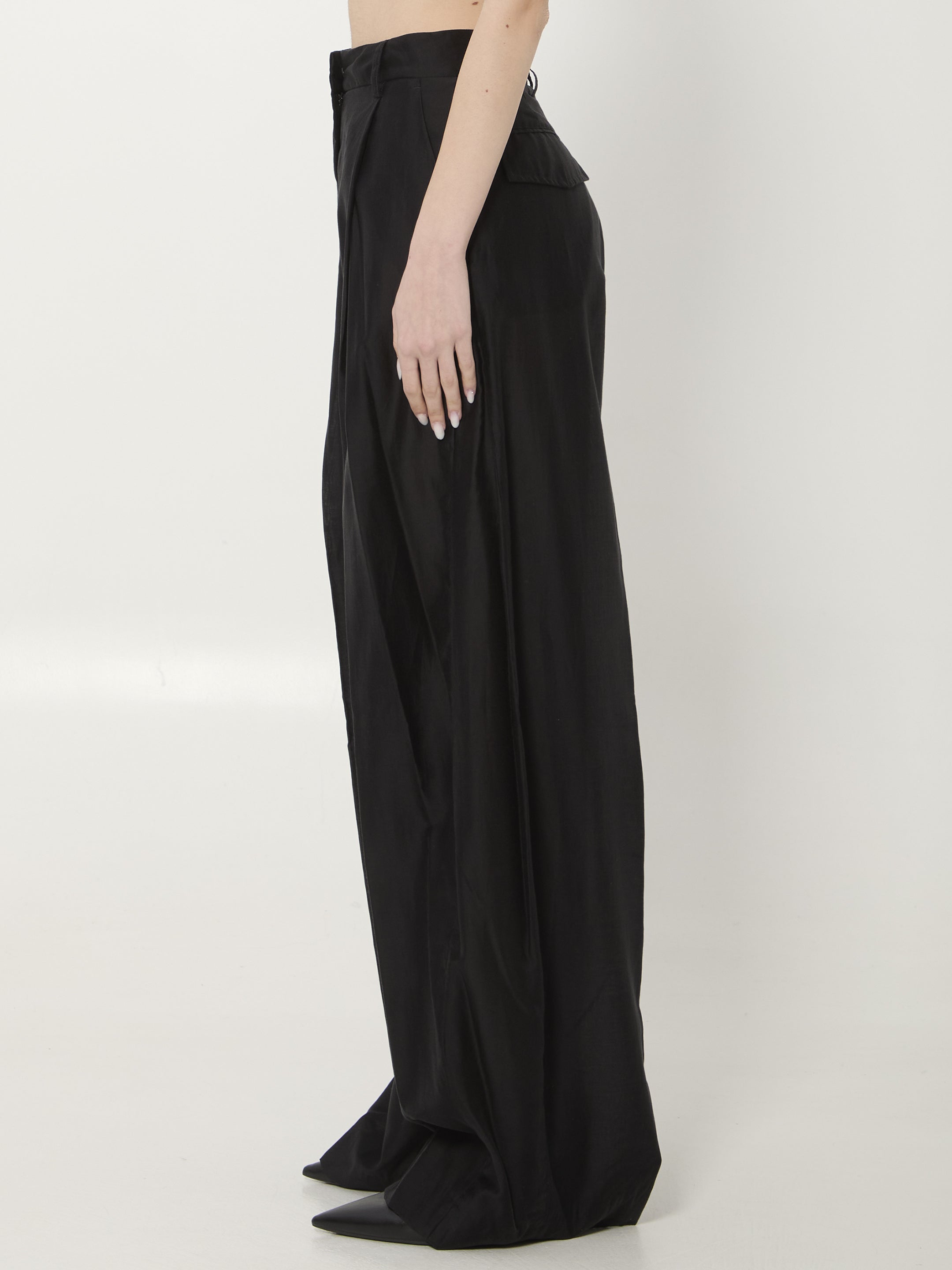 Black muslin wide leg trousers by THE LATEST, back view with flap pockets