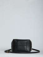 Black calfskin hobo bag by Celine showing button closure detail