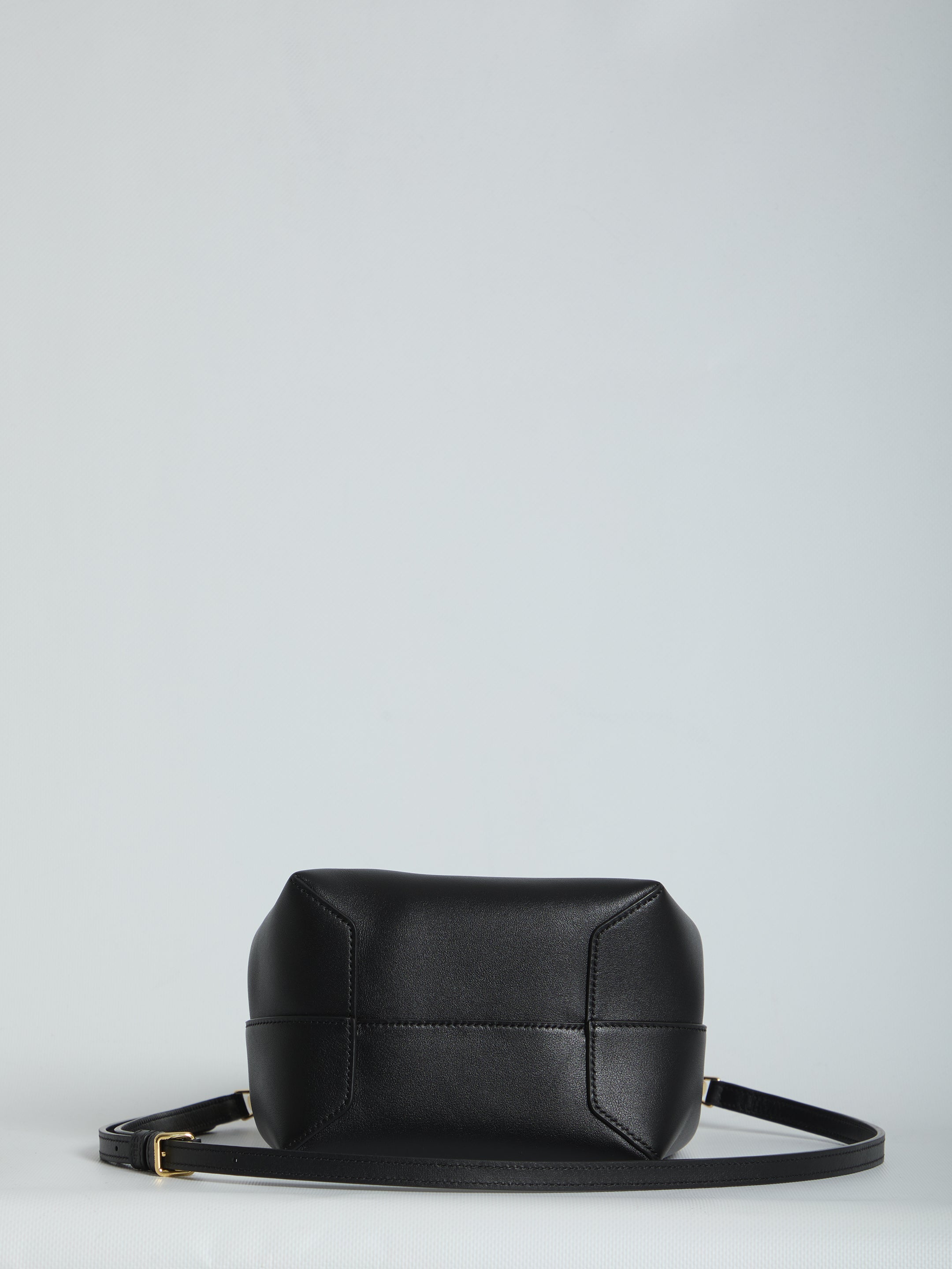 Black calfskin hobo bag by Celine showing button closure detail