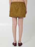 Caramel brown Gucci GG nylon mini skirt, close-up of GG print