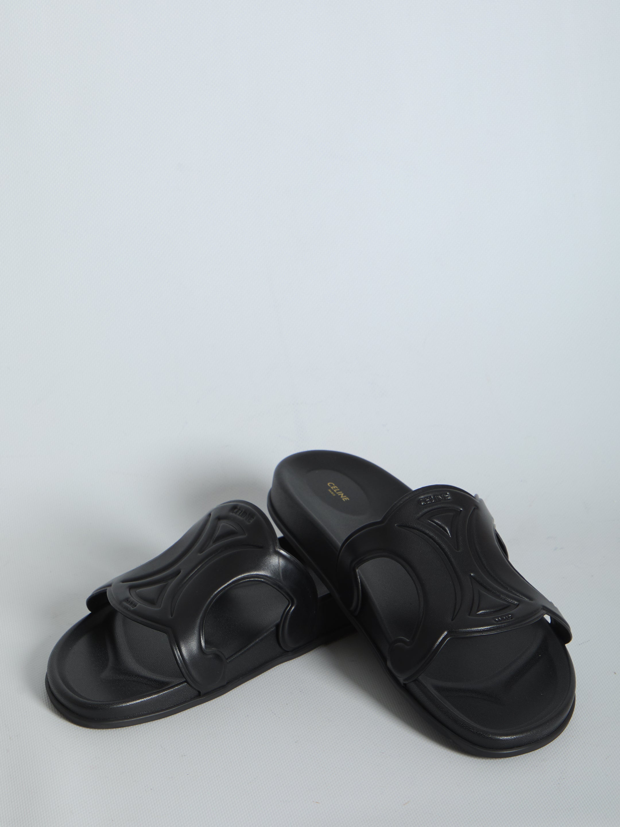 Black Celine Triomphe slide sandal, angled view by Celine
