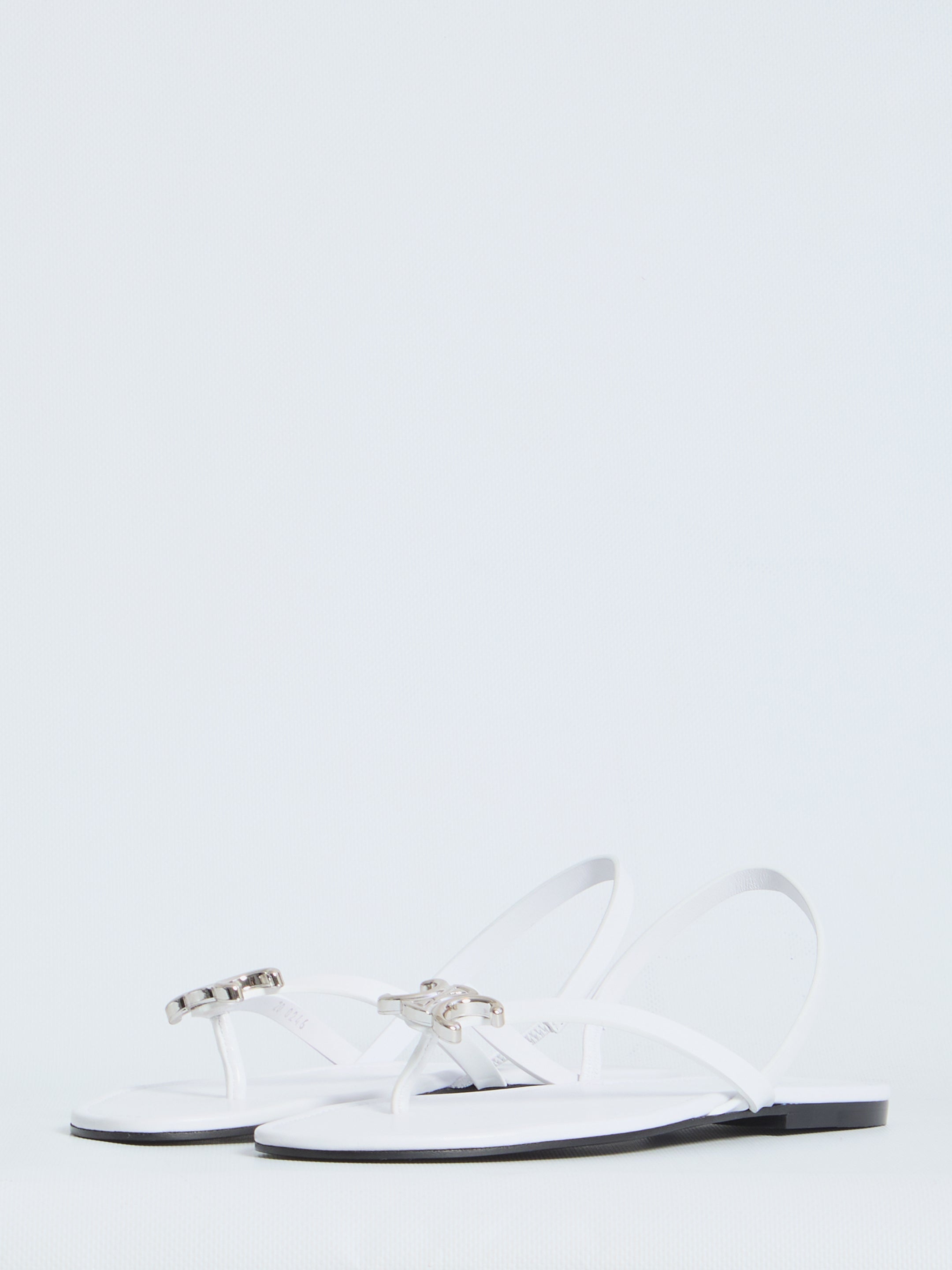White Celine slider sandals with silver-tone Triomphe detail, front angle