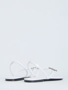 White leather Celine slider sandals showing elasticated back strap, rear view