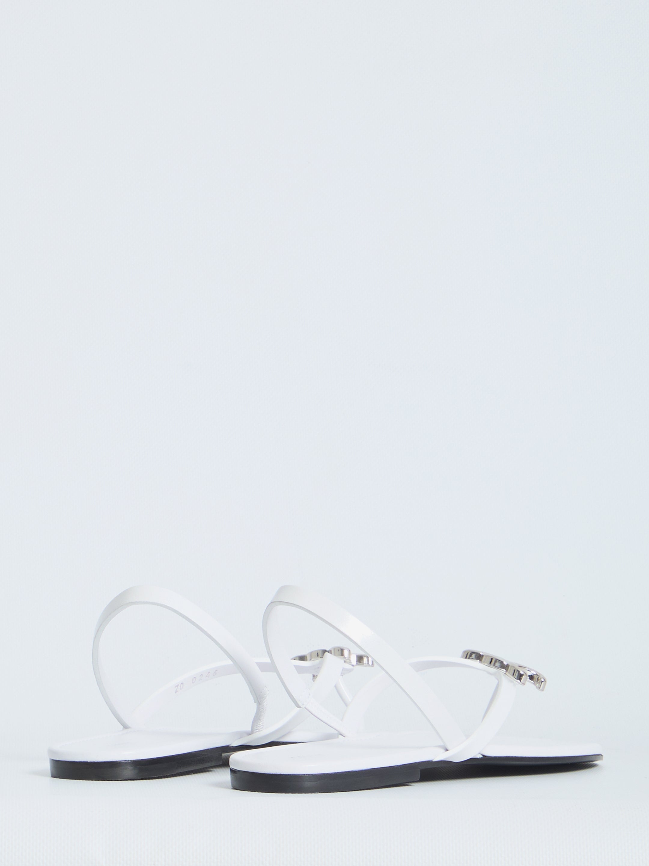 White leather Celine slider sandals showing elasticated back strap, rear view