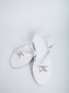 White calf leather slider sandals by Celine showing leather sole, bottom view