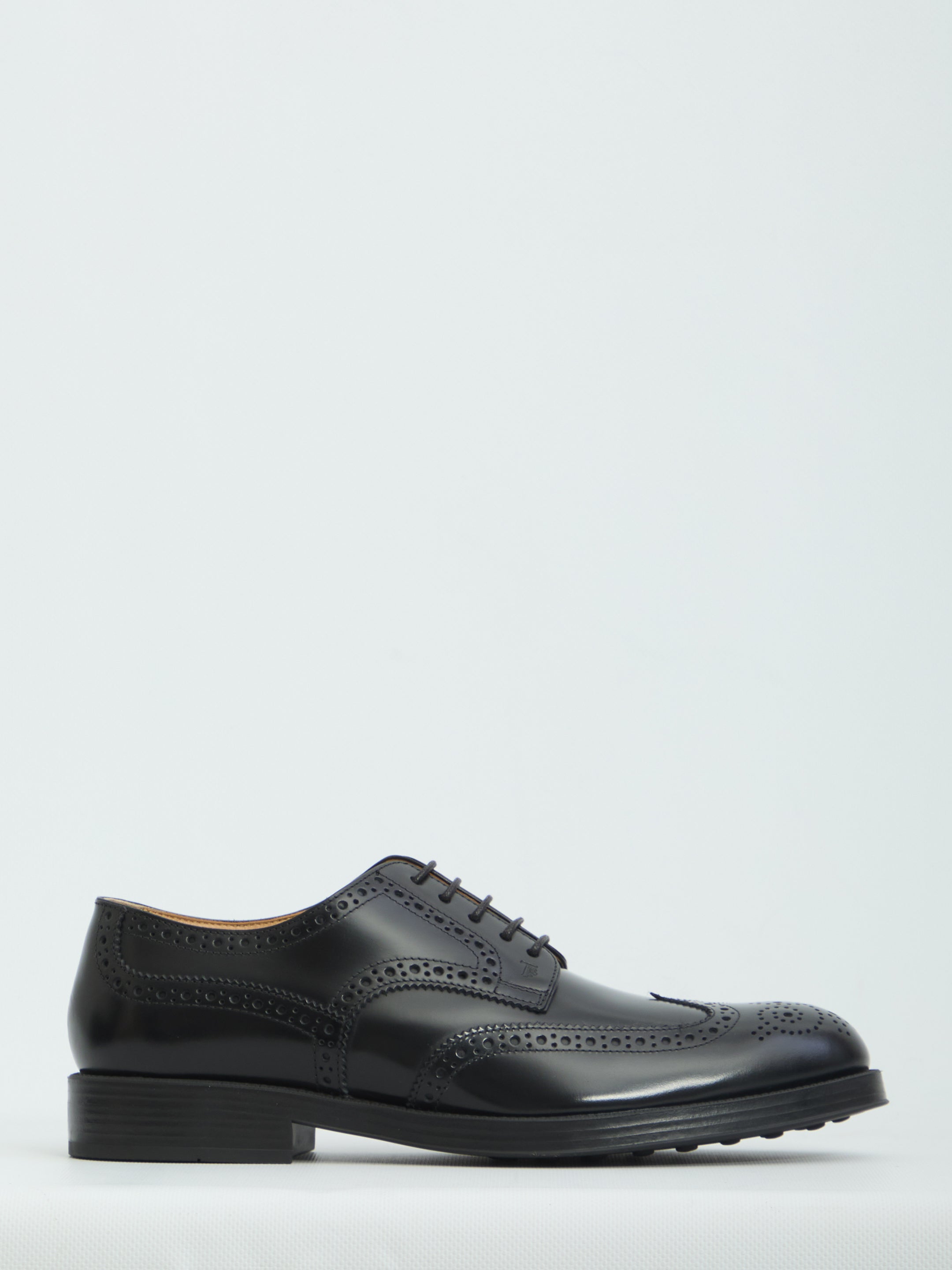 Black patent leather wingtip dress shoes by Tod's, side view