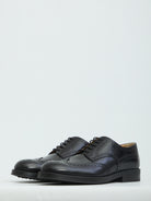 Black patent leather wingtip dress shoes by Tod's, front view