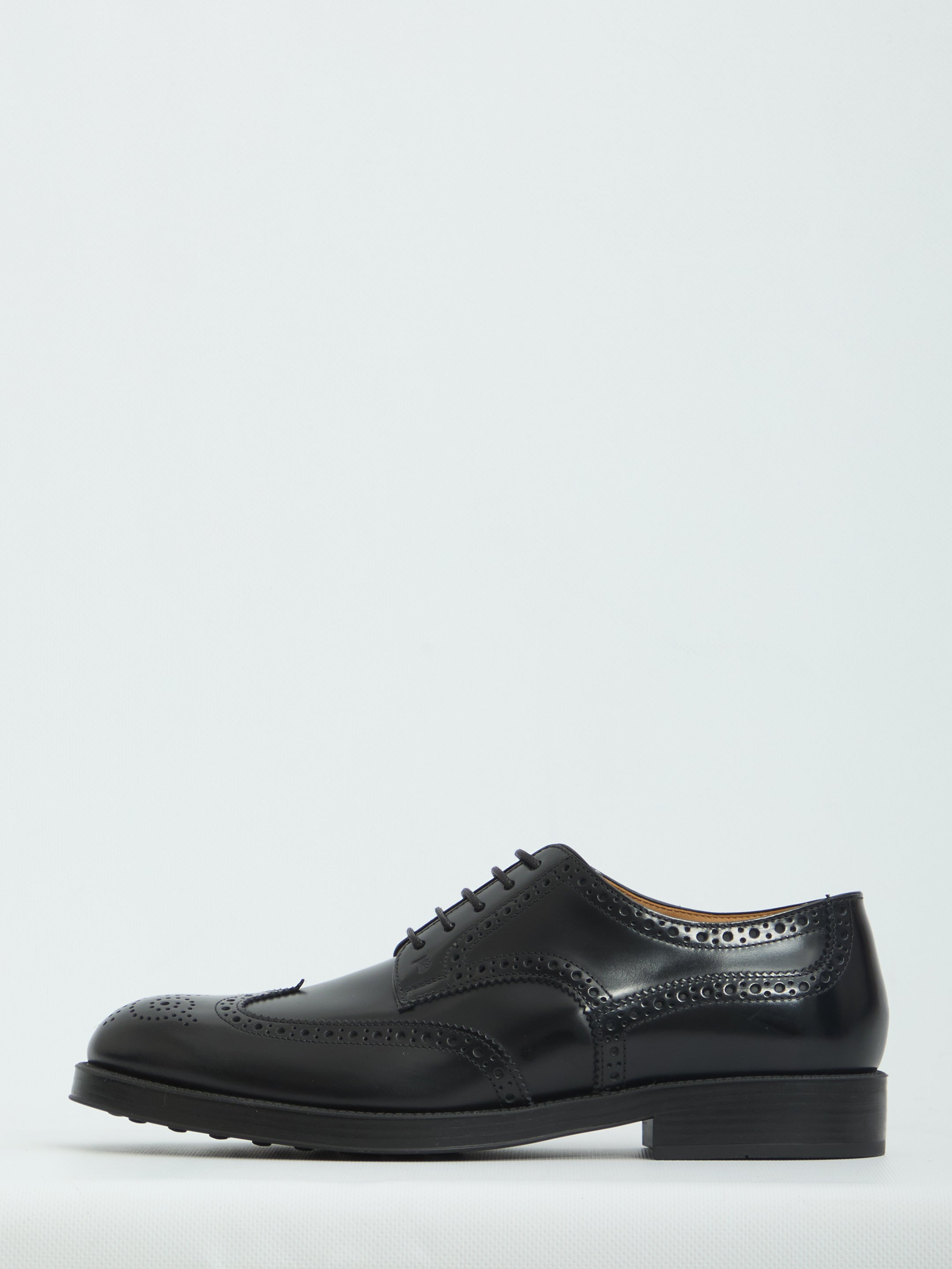 Black patent leather wingtip dress shoes by Tod's, sole view with rubber injection