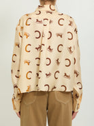 Cream Celine silk twill shirt detail showing pointed collar and button closure