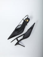 Saint Laurent Renée pump showing elongated toe and Cassandre embroidery, close-up