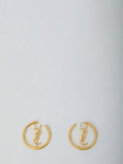 Gold-toned Saint Laurent Cassandre hoop earrings showing butterfly clasp detail
