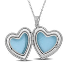 Sterling silver heart locket pendant open to show interior photo compartment, detail view