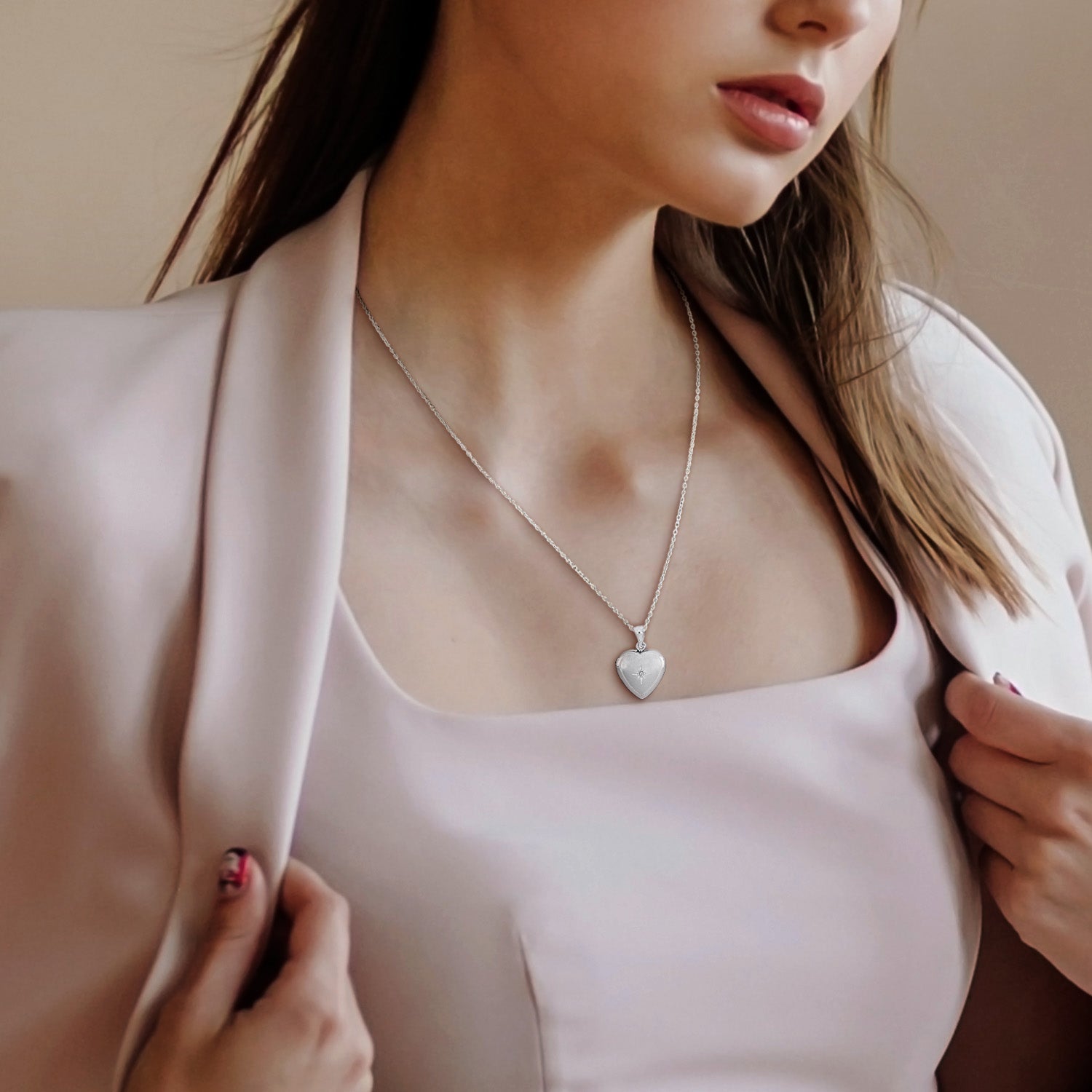 Sterling silver heart locket necklace worn on model by Lord & Taylor
