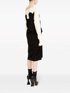 Black and off-white Maison Margiela midi dress with contrast stitching, side view