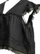 Black GANNI linen blouse detail showing lace trim finish, close-up