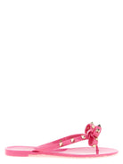 Fuchsia Rockstud flip flop sandals with pyramid studs by Valentino Garavani, front view