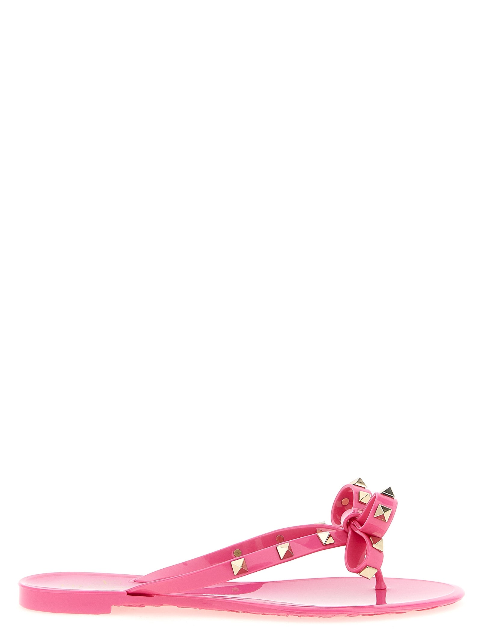 Fuchsia Rockstud flip flop sandals with pyramid studs by Valentino Garavani, front view