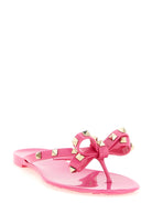 Fuchsia Rockstud flip flop sandals with bow detail by Valentino Garavani, side view