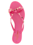 Fuchsia Rockstud flip flop sandals by Valentino Garavani, sole view
