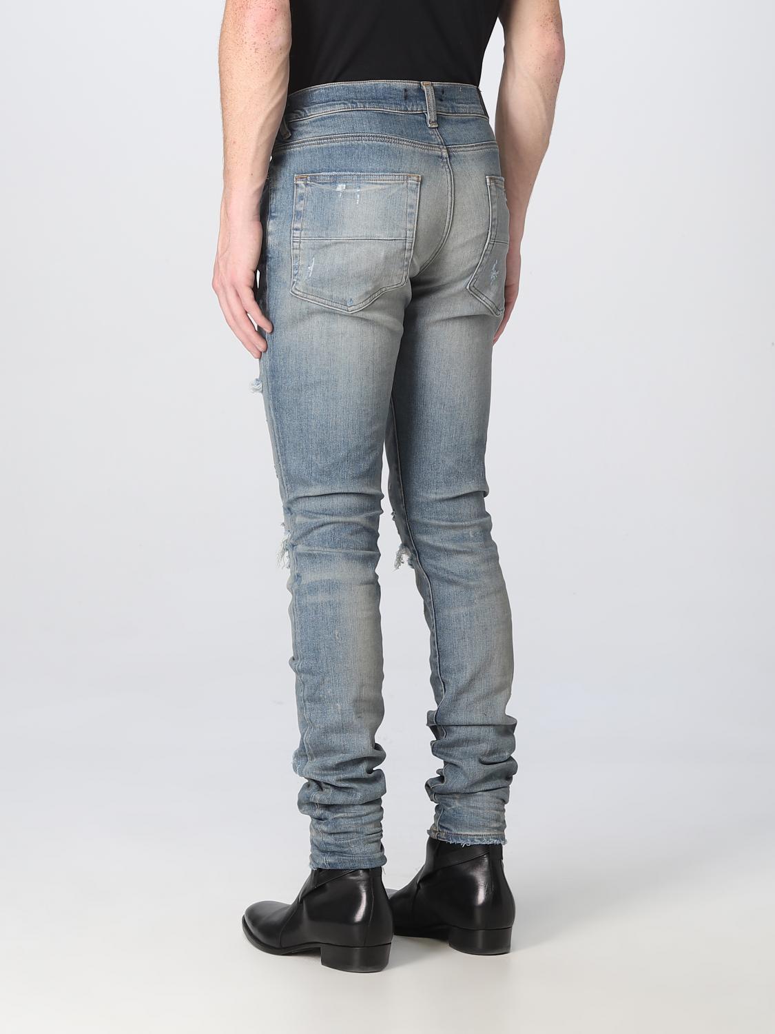 Clay indigo Amiri Thrasher Plus jeans showing ripped knee detail, side angle by Amiri