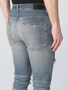 Clay indigo Amiri Thrasher Plus slim-fit jeans with five-pocket construction, back view by Amiri