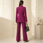 Magenta double-breasted blazer showing nipped-waist silhouette, back view