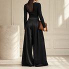 Black satin palazzo trousers back view showing floor-length hem by Lord & Taylor Heritage
