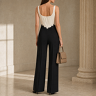Black wide-leg trousers with high waist construction, back view detail