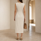 Cream pencil dress back view showing boat neckline and sleeveless construction