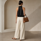 Black halter-neck satin shirt back view showing open back and bare shoulders