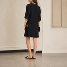 Black Celine Cady dress back button closure and slit detail, close-up back