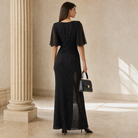 Black flutter-sleeve gown by Lord & Taylor Heritage, back view with draped shoulders
