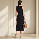 Black matte crepe midi dress with lace trim detail, back view close-up