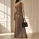 Bronze sequin one-shoulder gown back view showing column silhouette