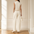 Cream barrel-leg trousers back view showing tapered ankle and center crease
