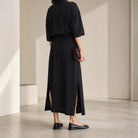 Black Lemaire asymmetrical dress hemline detail, close-up back