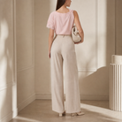 Beige wide-leg trousers with pleated front, three-quarter view by Lord & Taylor Heritage