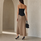 Black strapless bustier top back view with curved hem detail