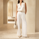 Champagne satin trousers waistband and pleat detail, close-up front view