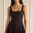 Brown STAUD Wells midi dress, close-up of structured bodice and scoop neckline