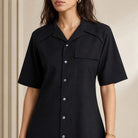 Black wool shirt dress collar and button detail, close-up front by AMI Paris
