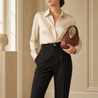 Black trousers front detail showing gold-tone button closure and pressed center crease by Lord & Taylor Heritage